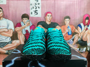 Front view of teal and black Nike basketball shoes with lace-up fastening.