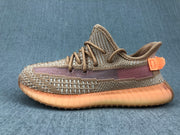Side profile highlighting the woven upper, purple stripe, orange heel tab, and ribbed gum-colored sole.