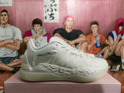 Side profile of a white sneaker with a sculpted sole