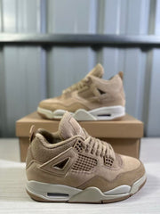 Close three-quarter view highlighting the tan upper, laces, mesh side panel, and heel cushioning window.