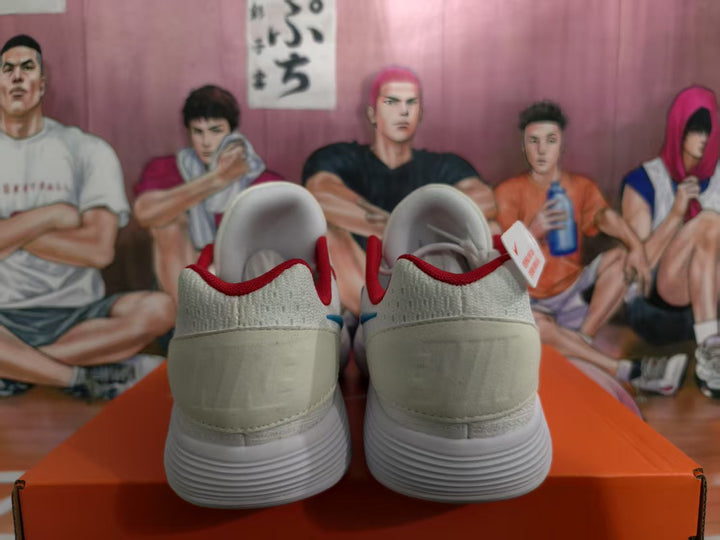 Rear view of white Nike sneakers showing red collar accents, textured uppers, and ribbed white outsoles.