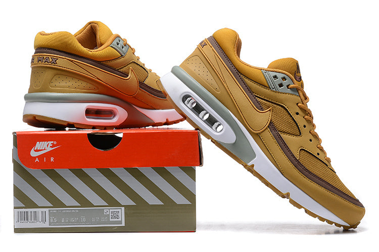 Ochre and brown Nike Air Max BW sneakers displayed on a Nike Air shoebox; the box label shows a sample size.