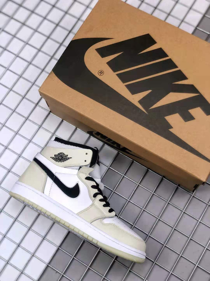 Air Jordan high-top sneaker beside a branded shoebox, showing the white, gray, and black colorway.