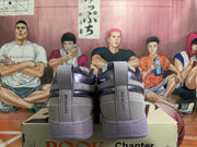 Rear view of gray and purple low-top sneakers with Chapter One heel tabs