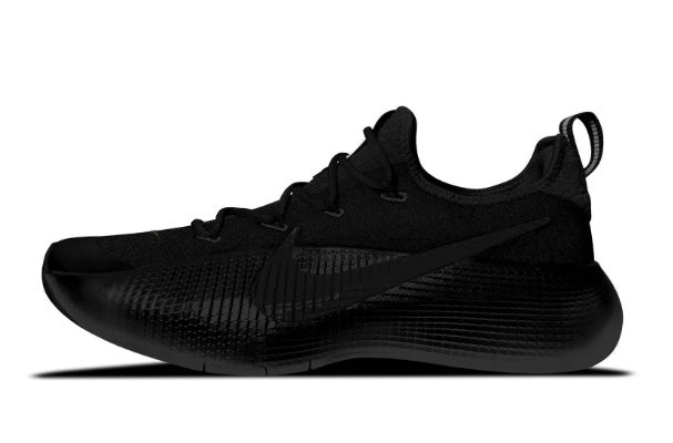Side view of an all-black low-top Nike lace-up running shoe with textured panels and a heel pull loop.