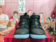 Front view of black Nike high-top basketball shoes with multiple straps and light blue outsoles.