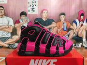 Side view showing oversized AIR lettering on black and bright pink Nike sneakers