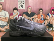 Side profile of a black and purple basketball sneaker with textured panels, contrasting side branding, and a speckled sole.