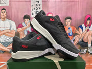 Angled view of paired black and grey Jordan sneakers with red accents and contrasting midsoles.