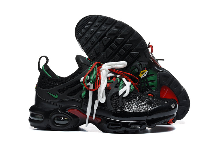 Nike Air Max Plus sneakers in black with green and red accents, shown from above and below.