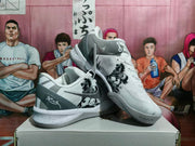 Angled view of the paired sneakers highlighting the side graphics, dark gray heel panels, Swoosh, and speckled midsoles.