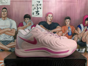 Side view of a pink Nike basketball shoe with a darker pink Swoosh and midsole detail.