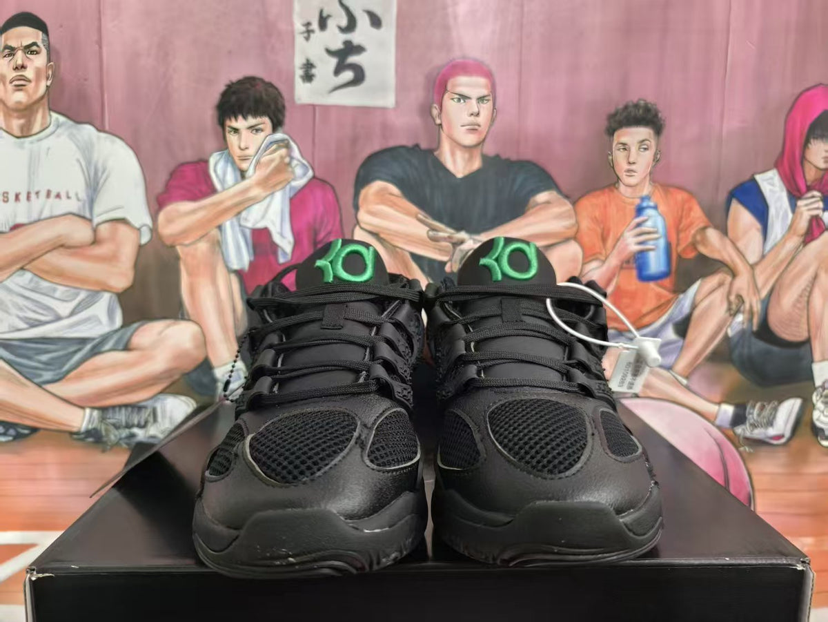 Front view of black Nike KD 4 basketball sneakers with green tongue logos and mesh toe panels.