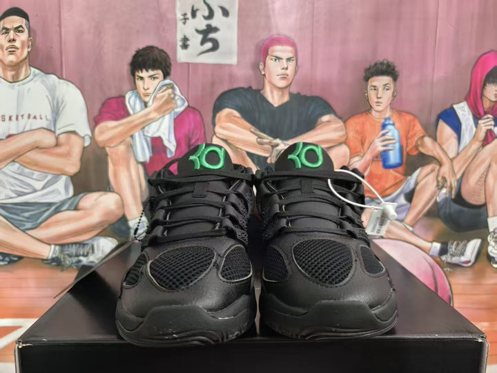 Front view of black Nike KD 4 basketball sneakers with green tongue logos and mesh toe panels.