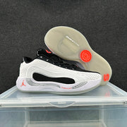Side and outsole views of a Jordan low-top shoe with translucent soles and red accents.