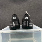 Rear view of the pair showing contrasting heel graphics, black uppers, and patterned outsoles.