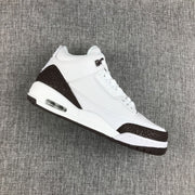 Angled view of the white and brown Jordan Air Jordan 3 sneaker showing the textured overlays and heel air unit.