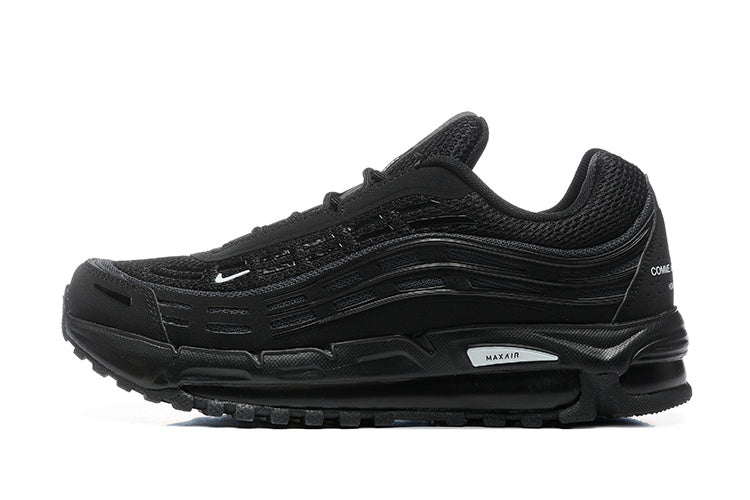 Side view of a black Nike Air Max 97-style sneaker with layered wavy panels and small white Swoosh detail.