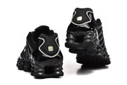 Rear views of black Nike Shox TL sneakers showing the heel and segmented sole.