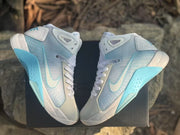 Top-down view of the pair displaying the white toe panels, translucent-looking side panels, and blue accents.