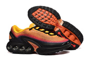 Nike Air Max DN sneakers shown from the side and underneath, highlighting the outsole and cushioning units.