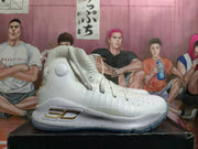 Side view of a white basketball shoe with gold side detailing and a speckled midsole