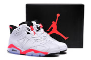 Pair of white, black, and bright red Air Jordan 6 high-top sneakers displayed beside a black Jordan shoebox.