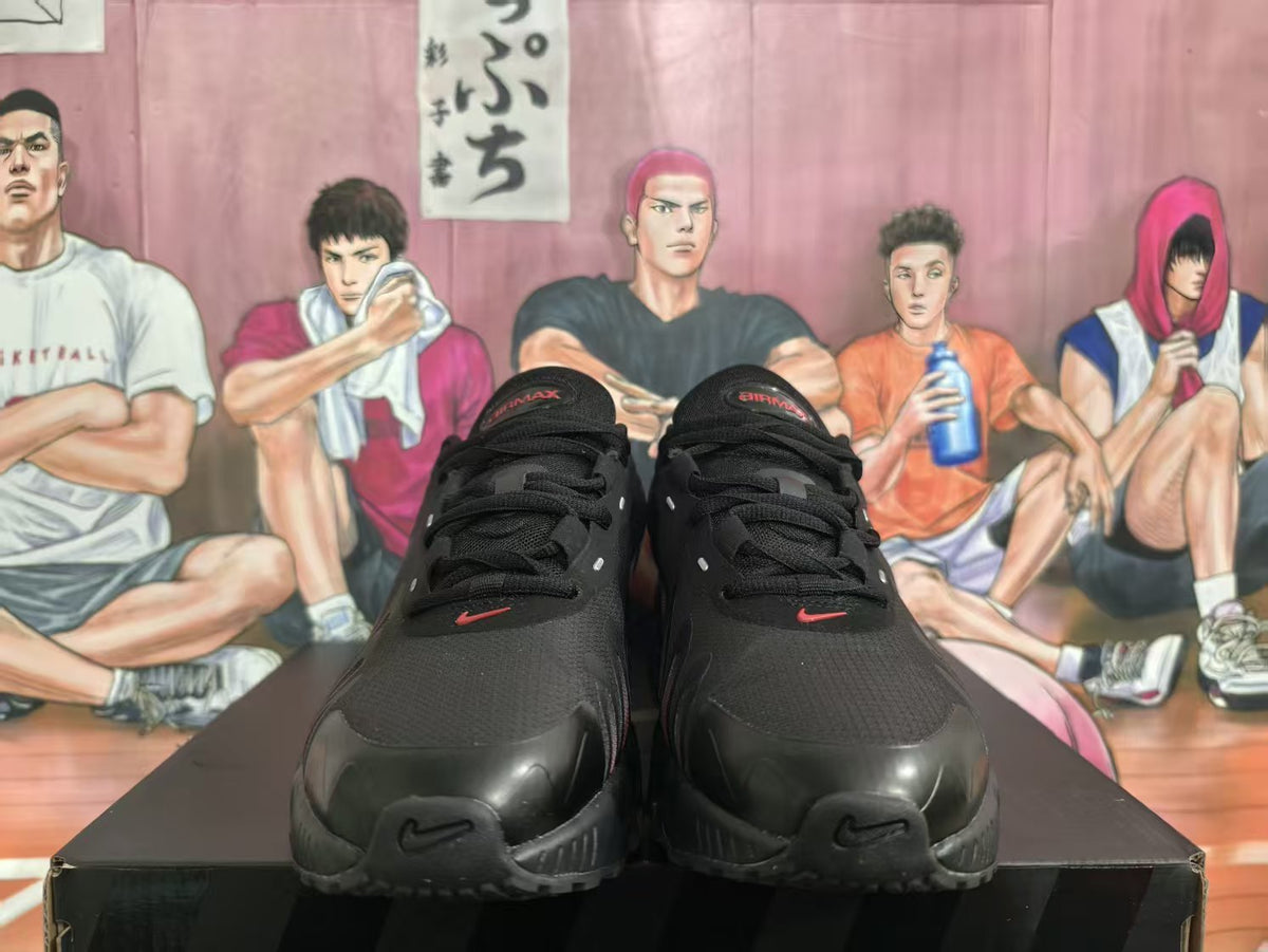 Front view of black Nike Air Max sneakers with dark red accents