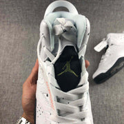 Close-up of the sneaker opening, padded collar, white laces, and branded tongue.