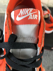 Close-up of the orange tongue with a white Nike Air label and black laces.