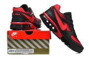 Black and red Nike Air Max sneakers displayed on a Nike Air shoe box; the box label shows a sample size of 8.5.