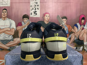 Rear view of navy and yellow basketball shoes with gray heel panels
