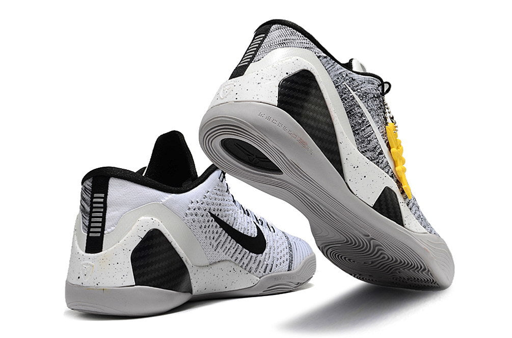 White and black Kobe 9 Low basketball shoes shown from the heel and outsole.