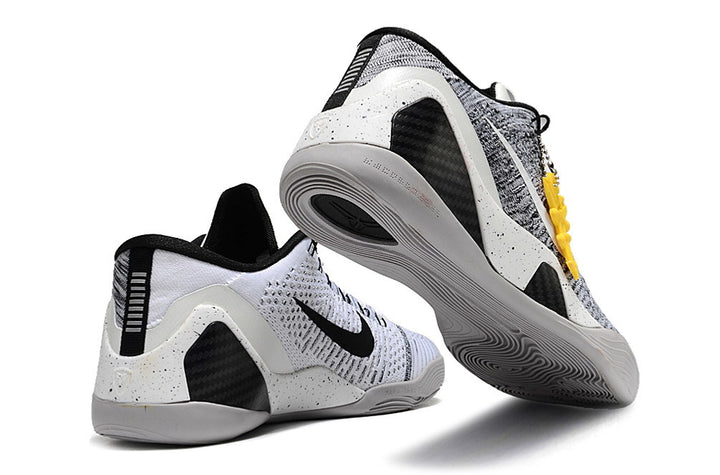 White and black Kobe 9 Low basketball shoes shown from the heel and outsole.