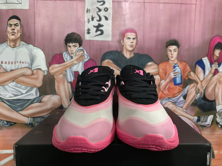 Front view of black and pink basketball sneakers displayed on a black shoe box.