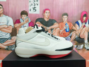 Side profile showing the white upper, side Swoosh, black trim, and red outsole of a Jordan basketball shoe.
