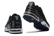 Rear and outsole views of black Nike Air Max Plus TN sneakers.