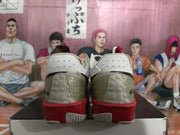 Rear view of the pair showing gray heel panels, red midsoles, and textured outsole sections.