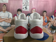 Rear view of white ASICS basketball sneakers with red heel panels