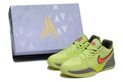 The sneakers are displayed beside a matching branded shoe box.