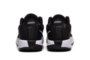 Rear view of the black and white Nike sneakers showing padded collars, heel details, and patterned outsoles.