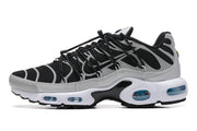 Side profile of a black and grey Nike Air Max Plus sneaker with white midsole and blue-tinted cushioning