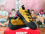 Pair of yellow and black Nike NDESTRUKT sneakers shown from the side