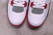 Top view of the white toe boxes, white laces, red trim, and mesh panels.
