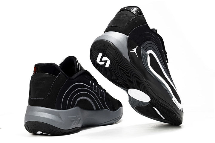Black and gray Jordan Luka 4 basketball sneakers shown from the rear and outsole angles.