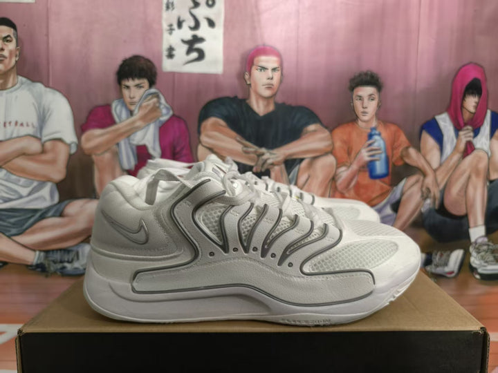 Side view of white Nike sneakers with layered gray-outlined panels and mesh-textured inserts on a box.
