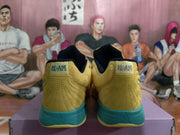 Rear view showing padded collars, stitched heel panels, blue-green heel sections, and small heel branding details.