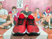 Front view of red and black Nike basketball sneakers showing black laces, textured red uppers, and white midsoles.