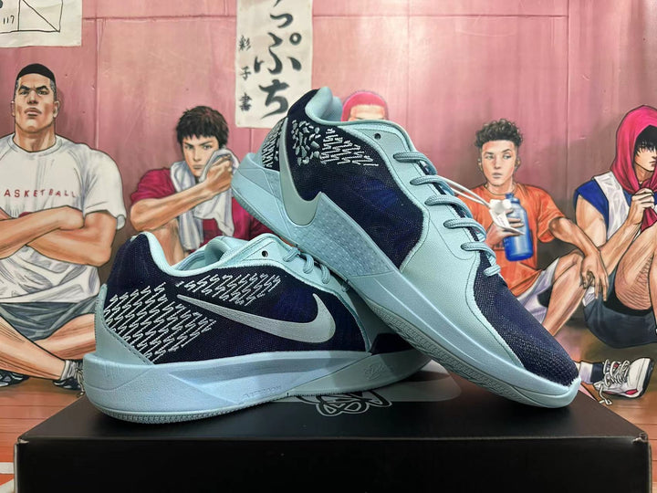 Pair of navy and light blue-gray Nike basketball shoes shown from the side