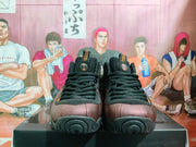 Front view showing black laces, padded tongues, brown toe panels, and orange accents on the sneakers.